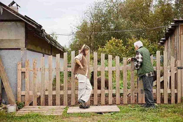 Expert installer securing cedar fence boards during a professional installation in Rockwall, TX