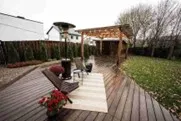 Custom-built backyard deck with pergola and seating area designed for outdoor living in Rockwall, TX.