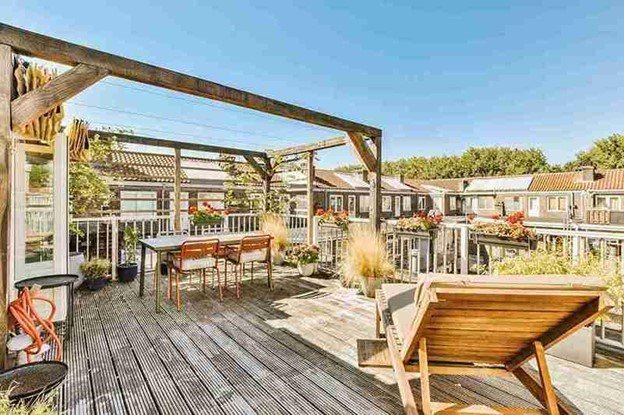Custom-built cedar deck and pergola providing shade and outdoor relaxation for a Rockwall, TX home